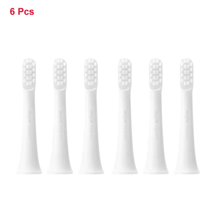 four white toothbrushes with white bristles on a white background