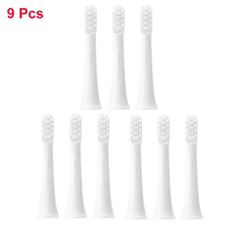 six white toothbrushes with white bristles on a white background