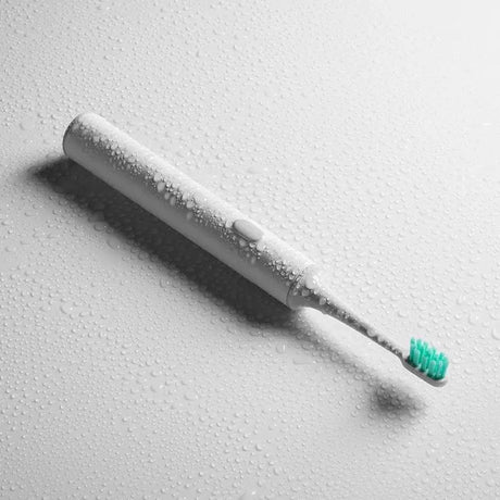 a toothbrush with water droplets on it