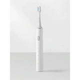 a white toothbrush with a blue toothbrush