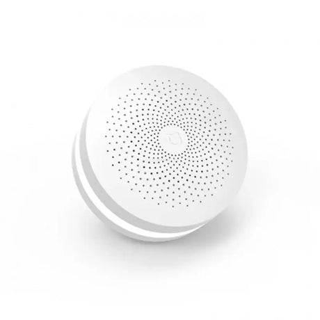 a white round speaker with a white dot pattern on it