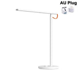 the lamp is white and has a white base with an orange cord
