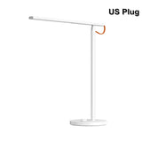 the u - plug table lamp is a white and orange led