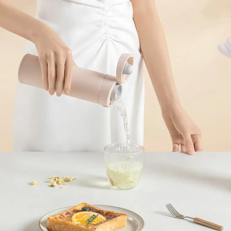 a woman pouring water into a plate of food