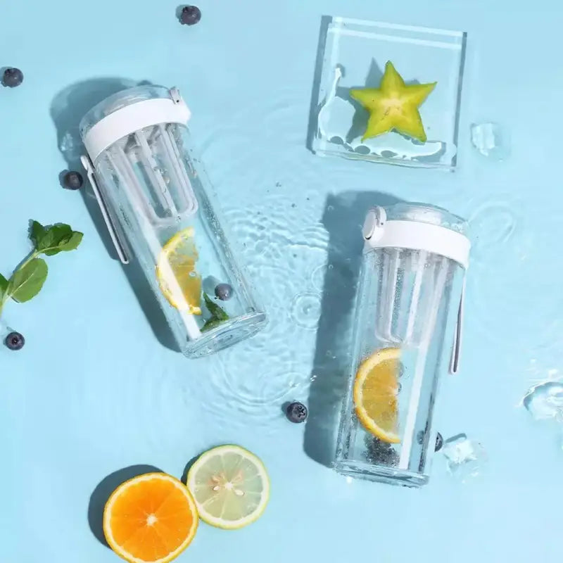 three water bottles filled with lemons, blueberries and lime