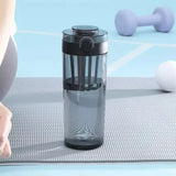 someone is doing a yoga exercise on a mat with a water bottle