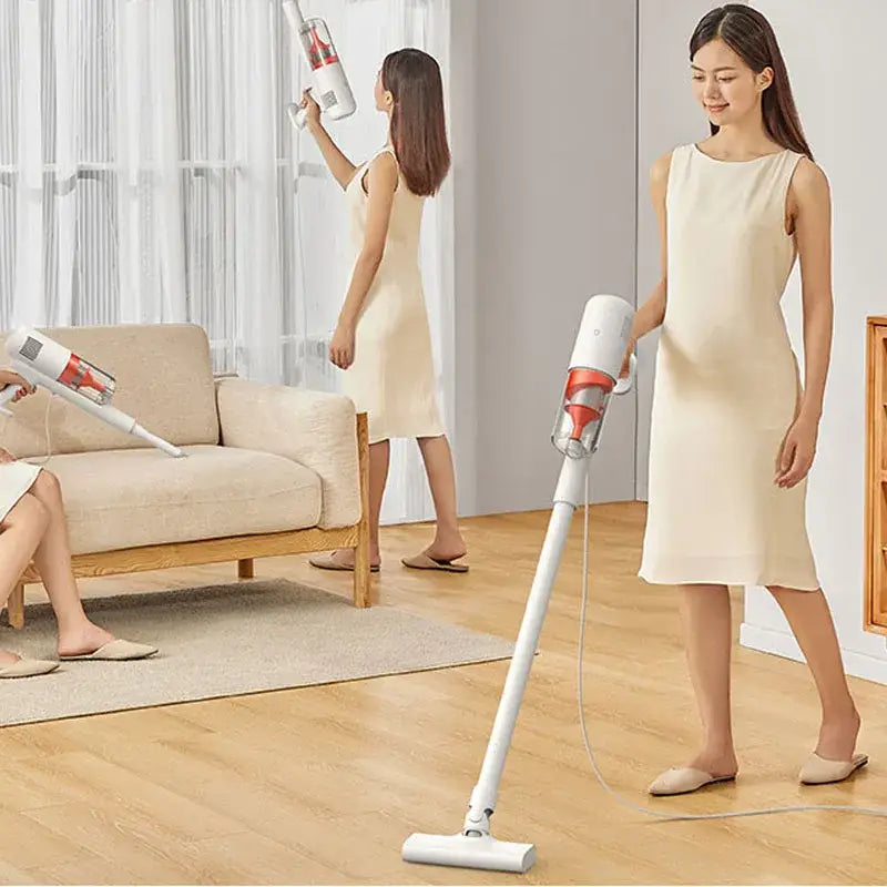 a woman vacuuming a living room with a vacuum