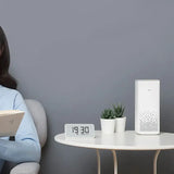 a woman sitting on a chair reading a book