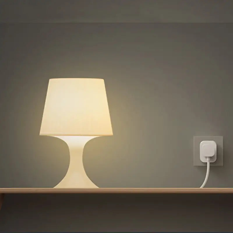 a lamp on a wall next to a bed