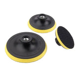 a pair of yellow and black polishing pads on a white background