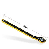 a yellow and black plastic ruler with a white background