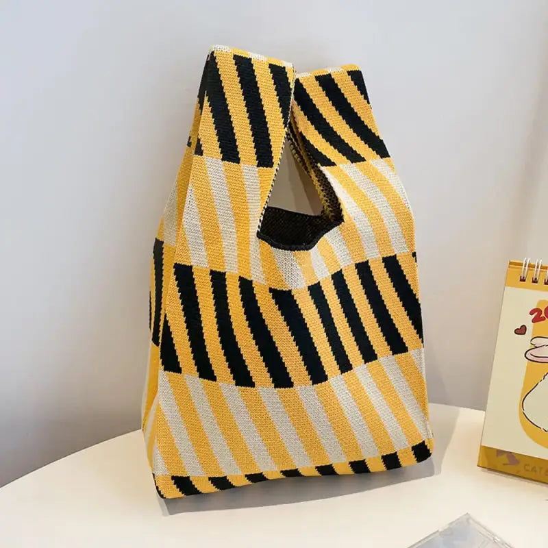 a yellow and black striped bag next to a box of tissues