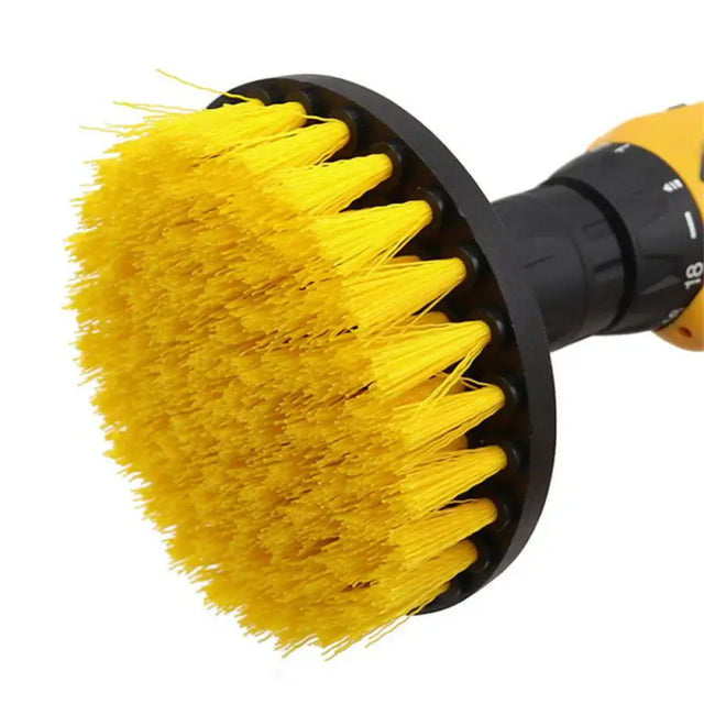 a yellow brush with a black handle