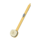 a yellow brush with a white handle