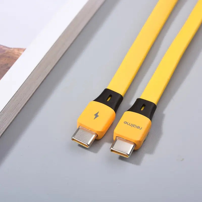 yellow usb cable with black ends and yellow ends on a table