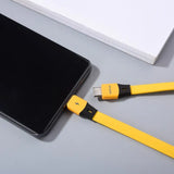 there is a yellow cable connected to a black phone