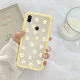 someone holding a phone with a yellow flower design on it