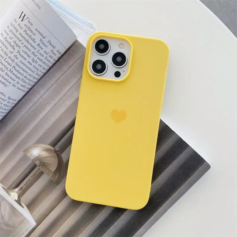 a yellow iphone case sitting on top of a magazine