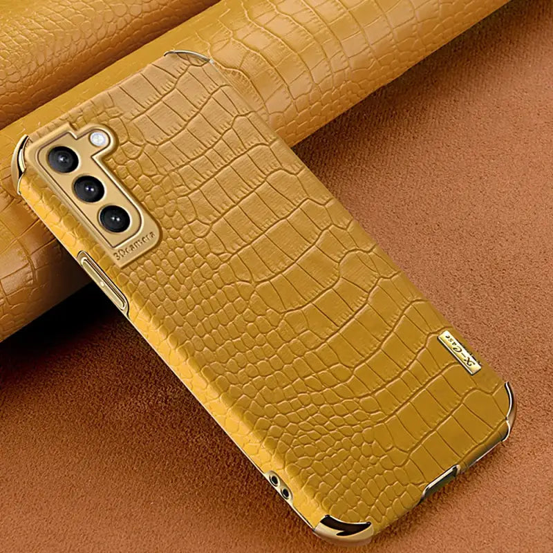 yellow leather case with a gold alligator skin for the iphone 11