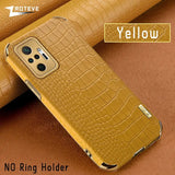 the back of a yellow leather case with a gold alligator skin