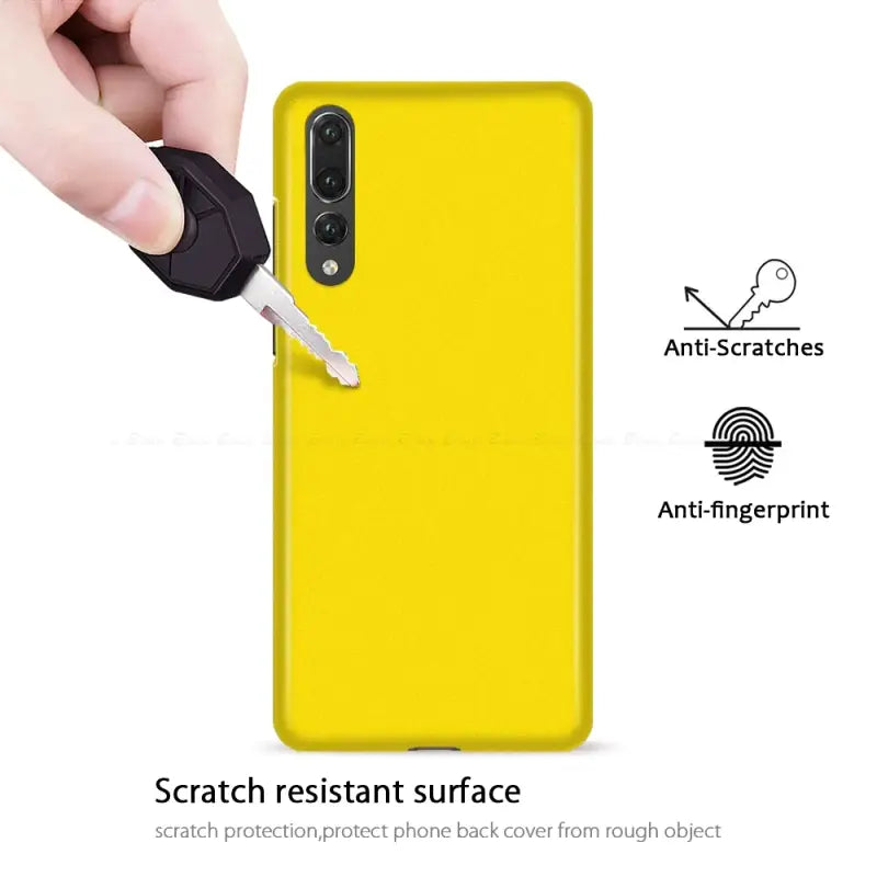 the back of a yellow phone case with a hand holding a key