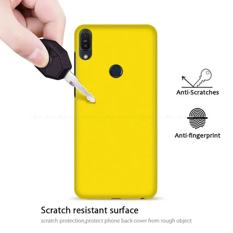 The back of a yellow phone case with a key in it