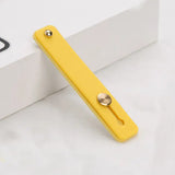 a yellow phone case with a metal button