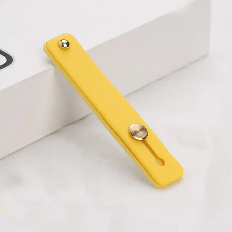 A yellow phone case with a metal button