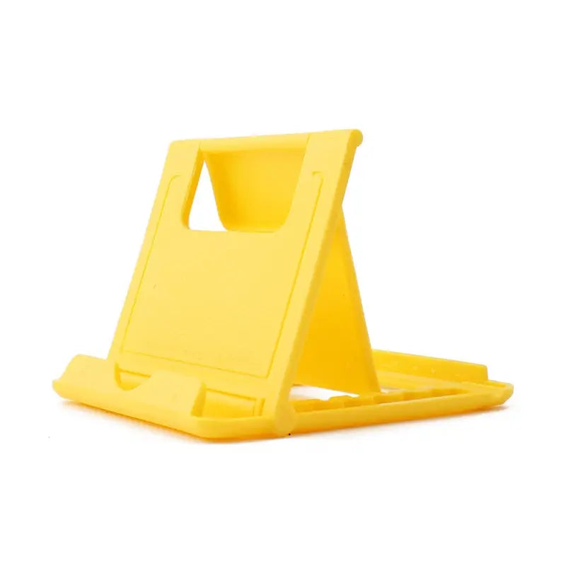 a yellow phone stand on a white background
