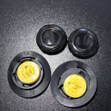 the yellow plastic knobs are shown on the black surface