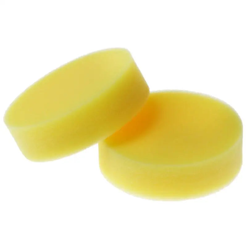 two yellow plastic ear plugs on a white background