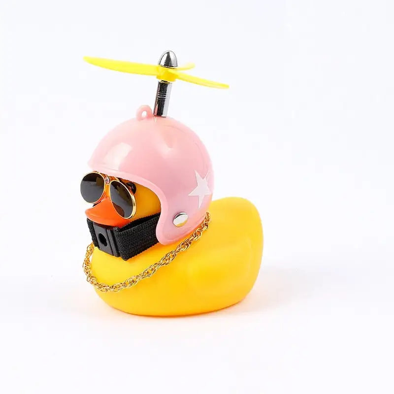 a yellow rubber duck with sunglasses and a pink helmet