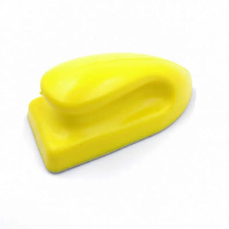 a yellow plastic heart shaped object on a white background