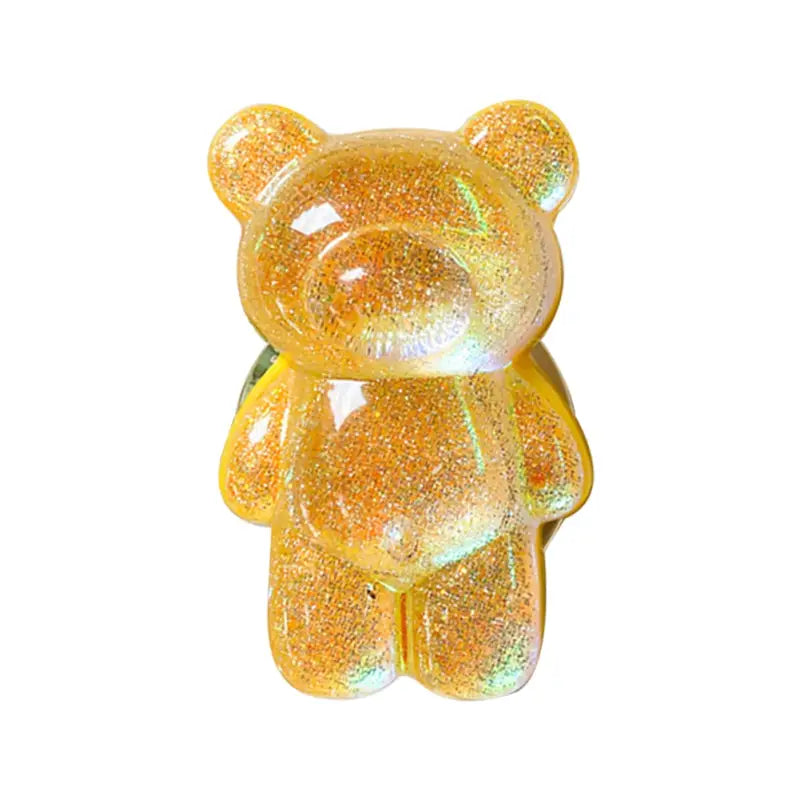 a yellow teddy bear with glitter on it