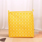 a yellow fabric bag with a pattern on it