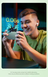 Young man smiling while looking at a smartphone and wearing wireless earbuds.