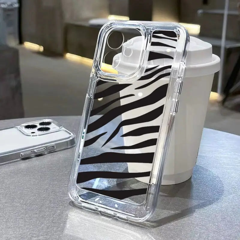 a zebra print phone case on a table