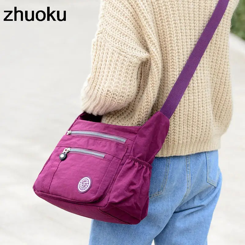 a woman wearing a purple bag with a purple strap