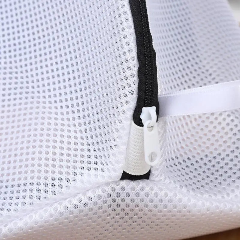 a zipper is attached to a white mesh bag